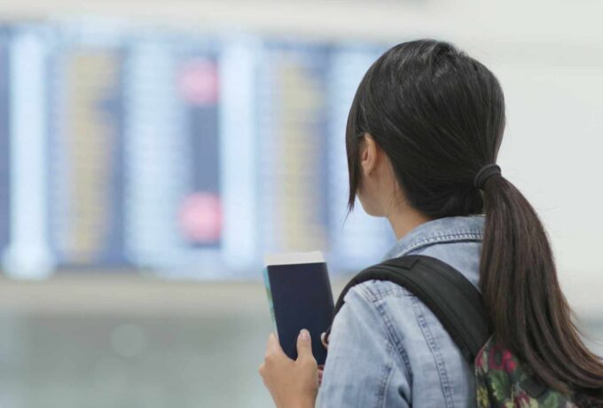Travel woman holding passport in the airport