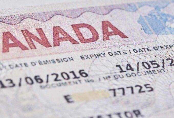 Tashkent, Uzbekistan - 13 August, 2021: Macro shot of Canadian visa. Close-up Canada resident immigration visa in passport